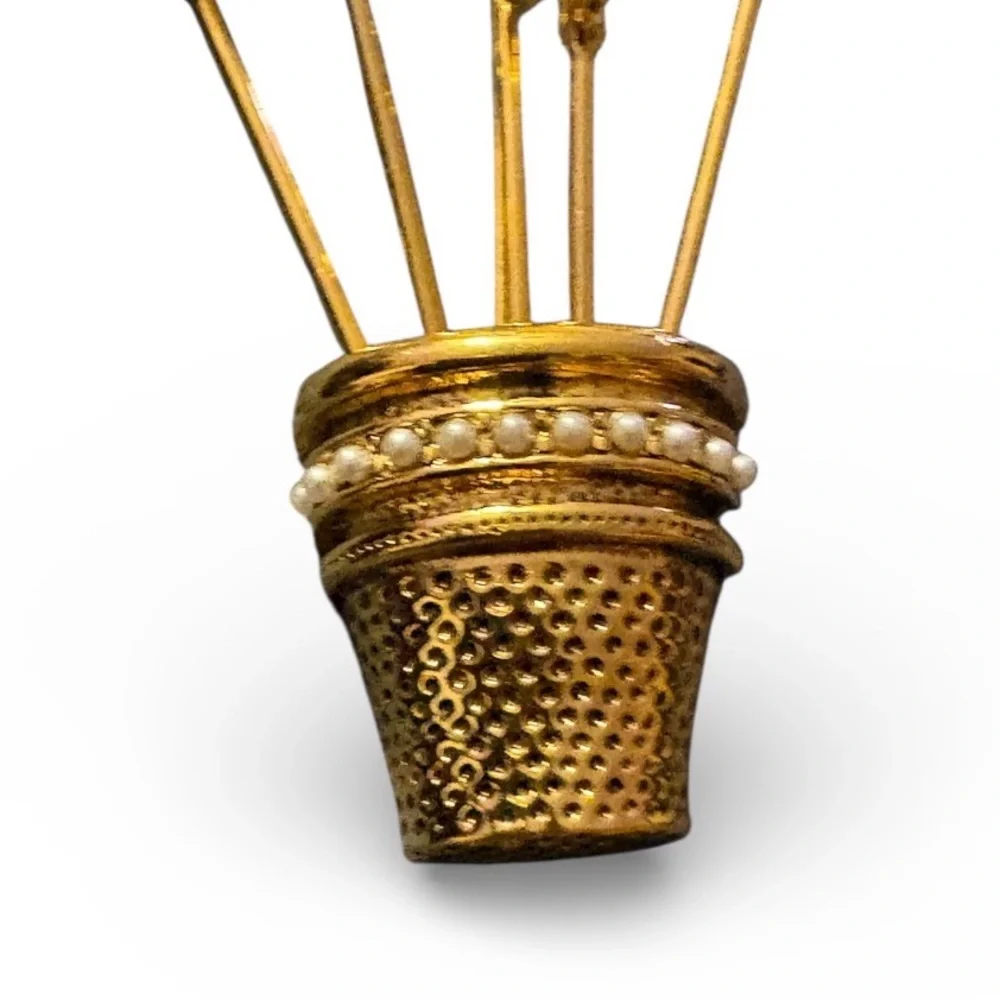 Vintage gold-plated thimble brooch with five stick pins.